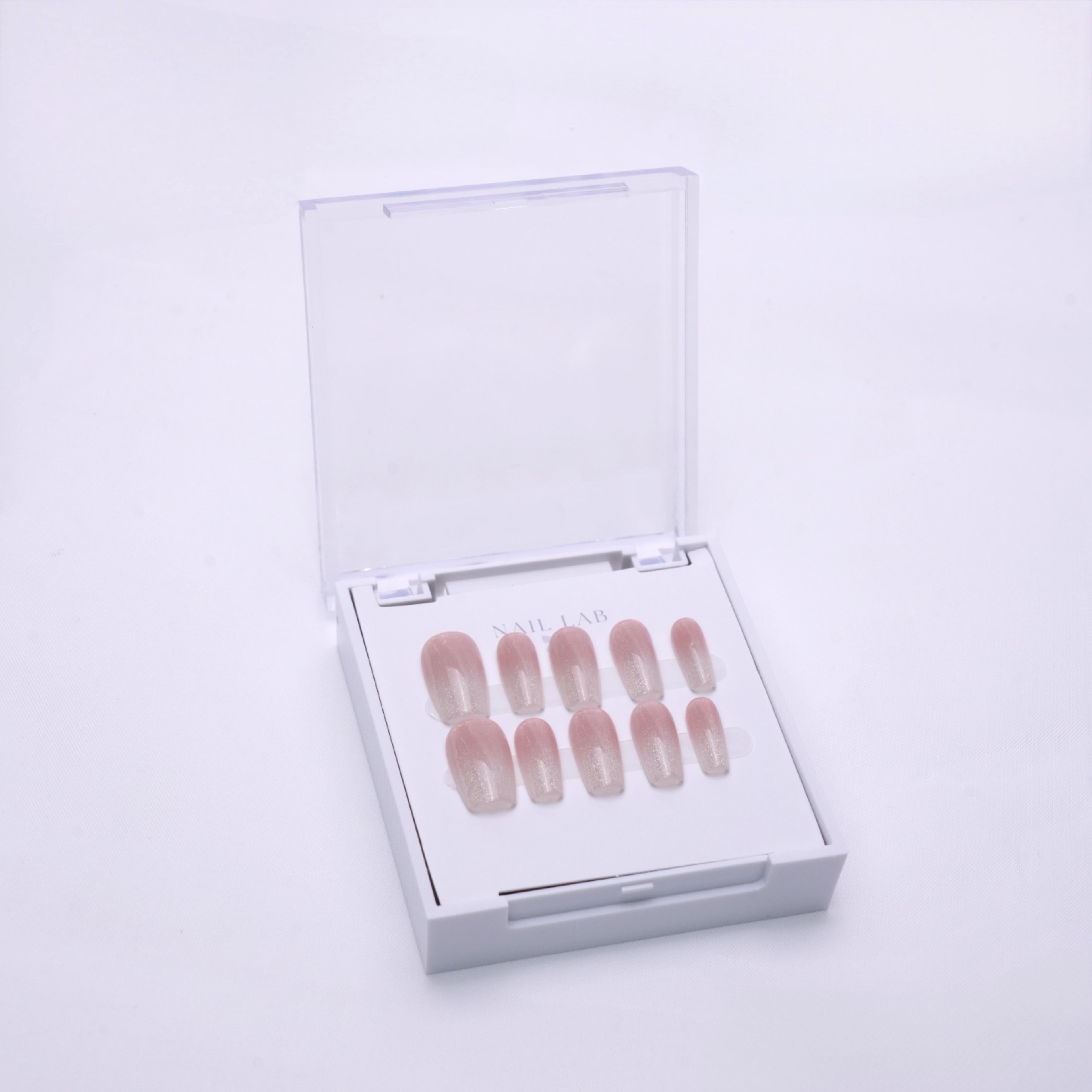 NAIL LAB LIGHTCURE press-on nails in sheer champagne nude with soft shimmer in case