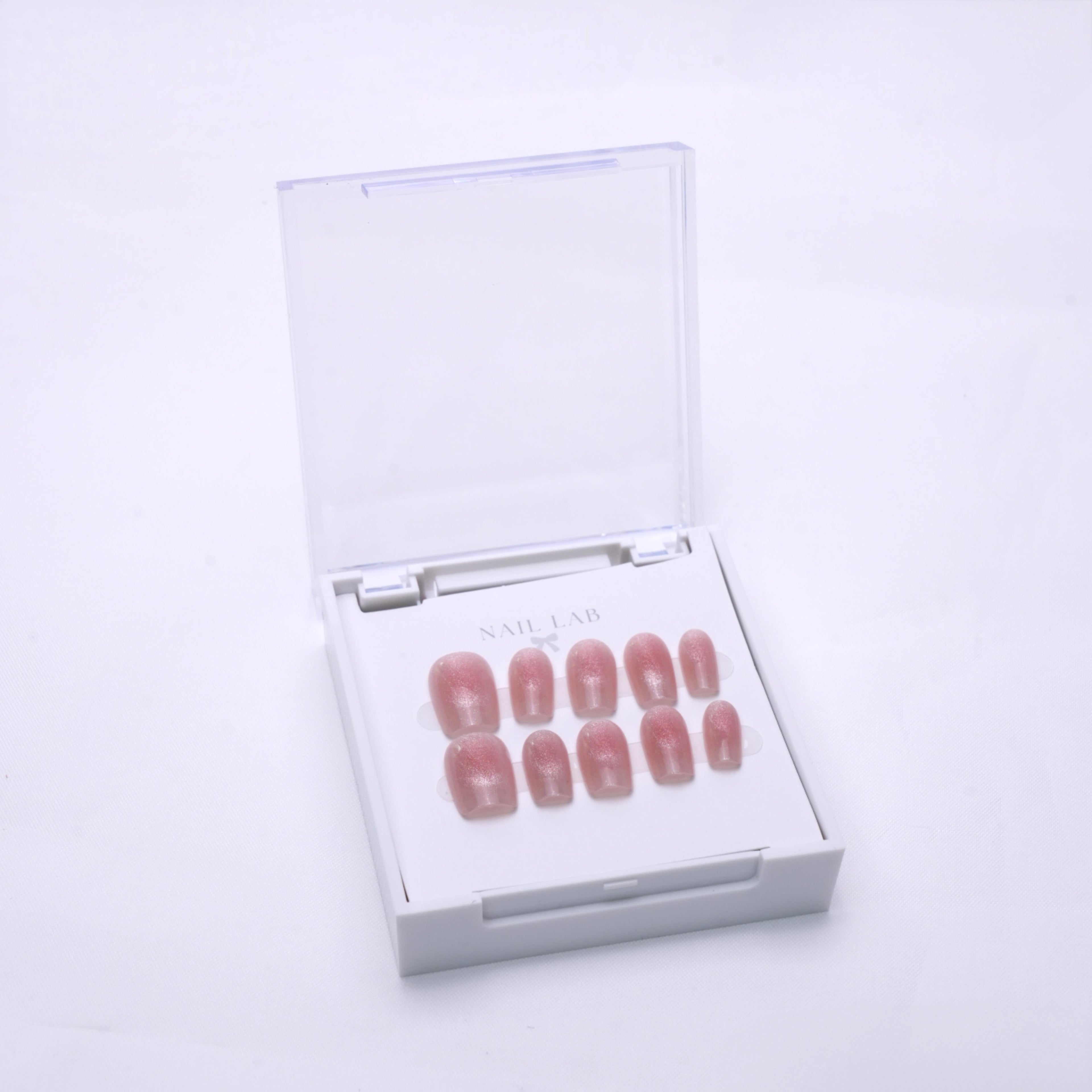 NAIL LAB LIGHTCURE press-on nails in blush pink with fine shimmer in case