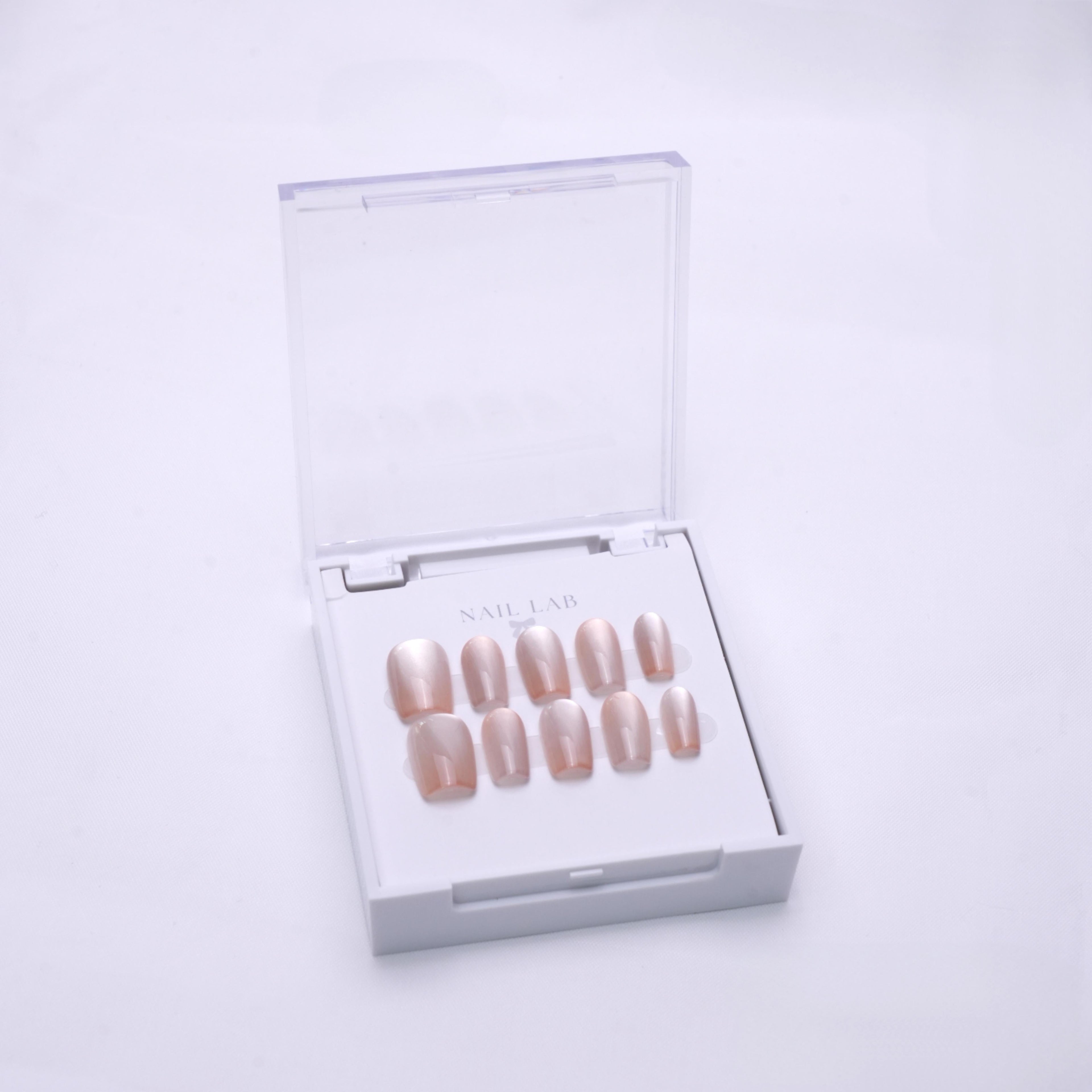 NAIL LAB LIGHTCURE press-on nails in warm beige nude with subtle glow in case