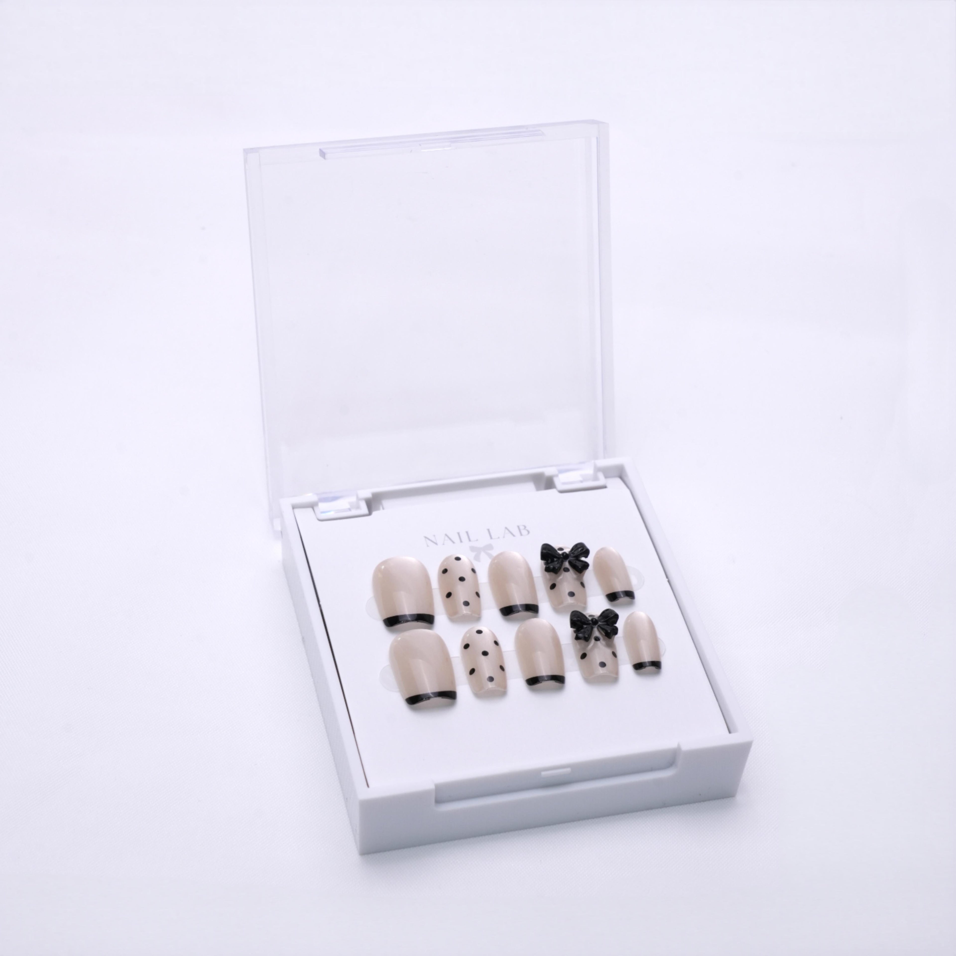 NAIL LAB LIGHTCURE press-on nails in soft nude with bow detail in case