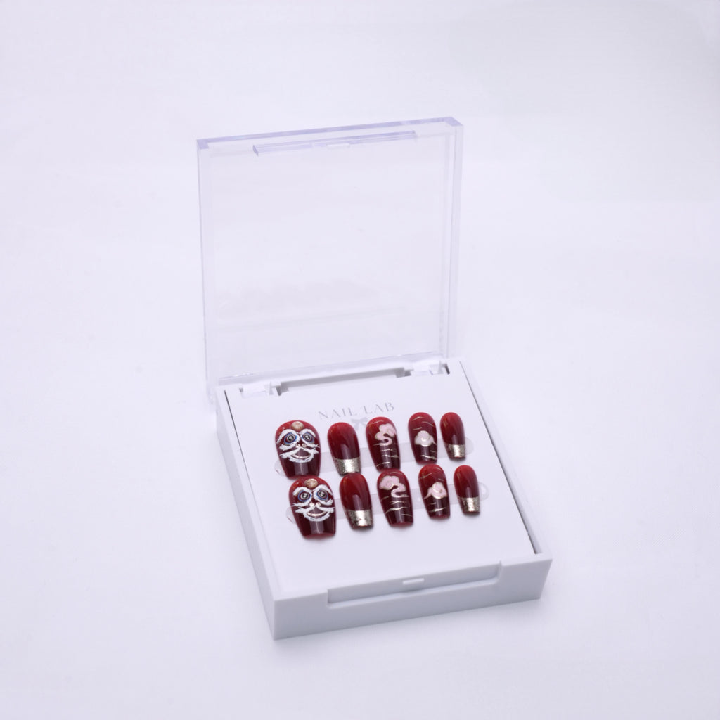 NAIL LAB LIGHTCURE press-on nails in red and gold lunar-inspired design in case
